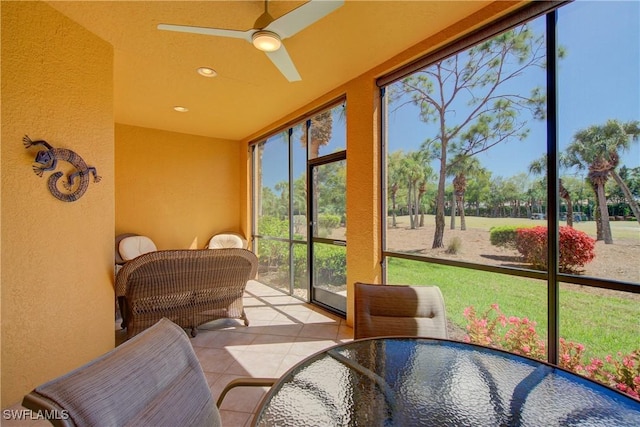 sunroom / solarium with a ceiling fan