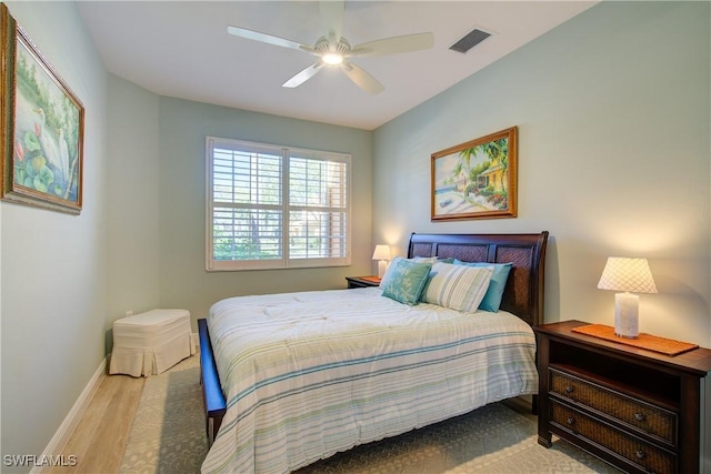 bedroom with visible vents, ceiling fan, baseboards, and wood finished floors