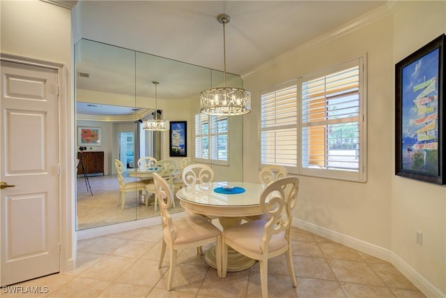 dining space featuring visible vents, an inviting chandelier, ornamental molding, light tile patterned flooring, and baseboards