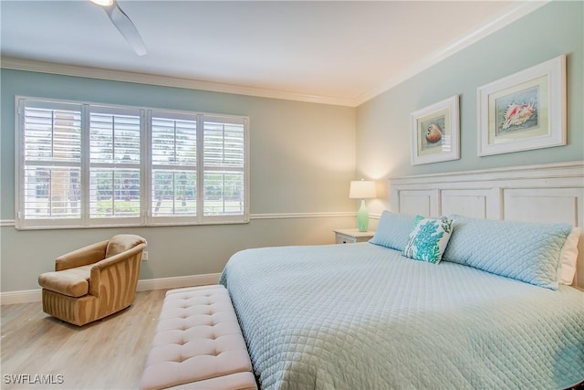 bedroom with baseboards, crown molding, and wood finished floors