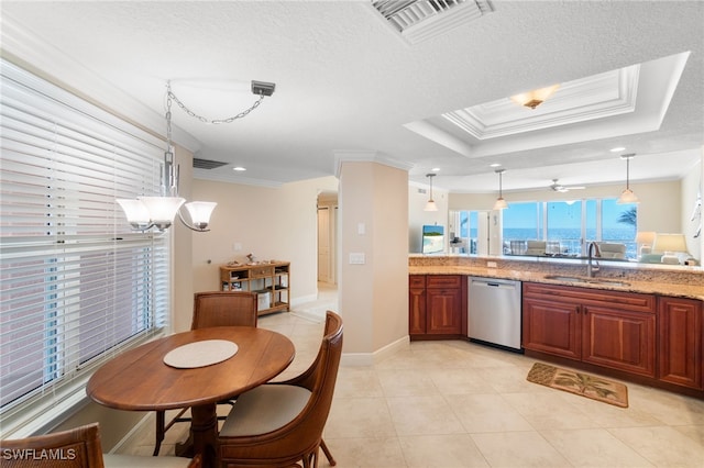 kitchen with a sink, visible vents, ornamental molding, dishwasher, and a raised ceiling