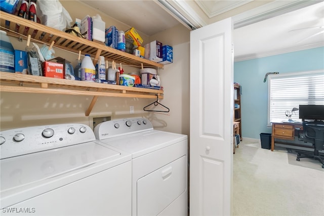 washroom with laundry area, washing machine and dryer, crown molding, and light colored carpet