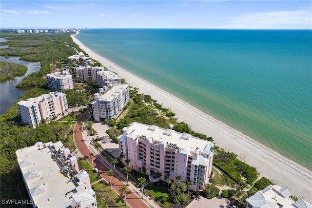 birds eye view of property featuring a water view, a view of the beach, and a city view