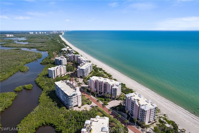 drone / aerial view with a water view, a view of city, and a view of the beach