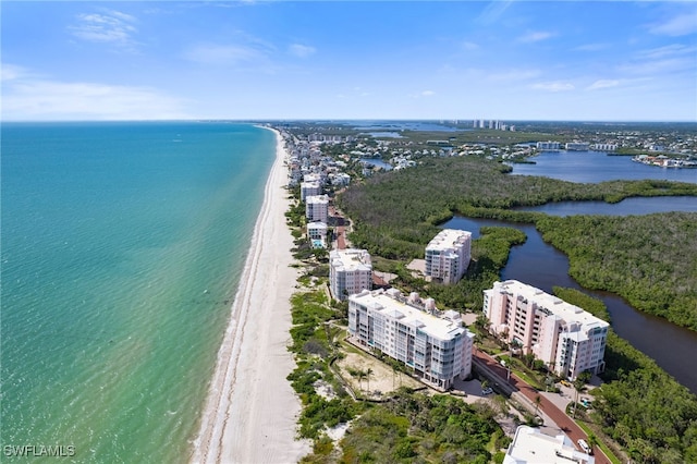 birds eye view of property featuring a beach view, a water view, and a city view