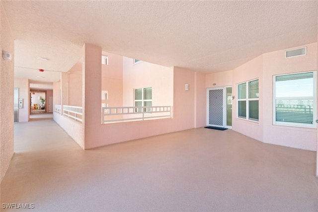 empty room featuring a textured ceiling and visible vents