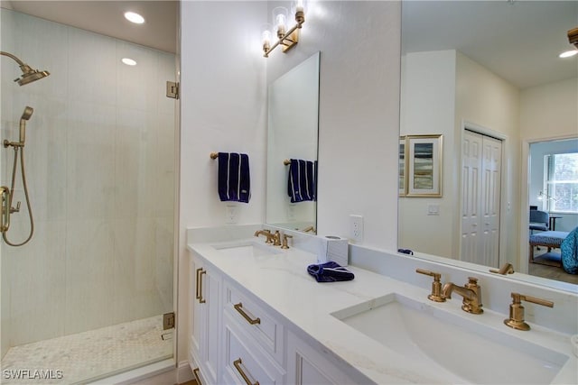 full bath with recessed lighting, tiled shower, a sink, and double vanity