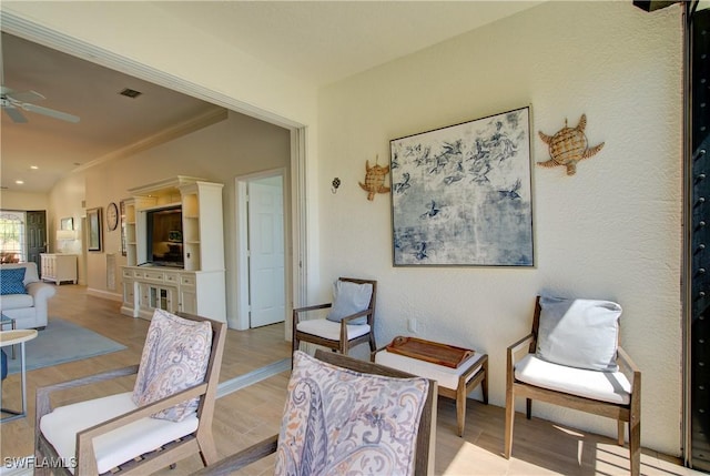 interior space with baseboards, a ceiling fan, and wood finished floors