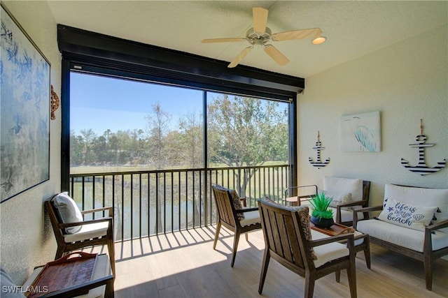 sunroom / solarium featuring a ceiling fan