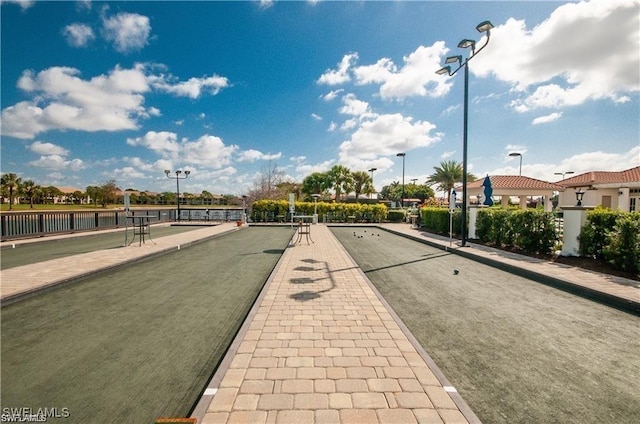 view of road with curbs, sidewalks, and street lights