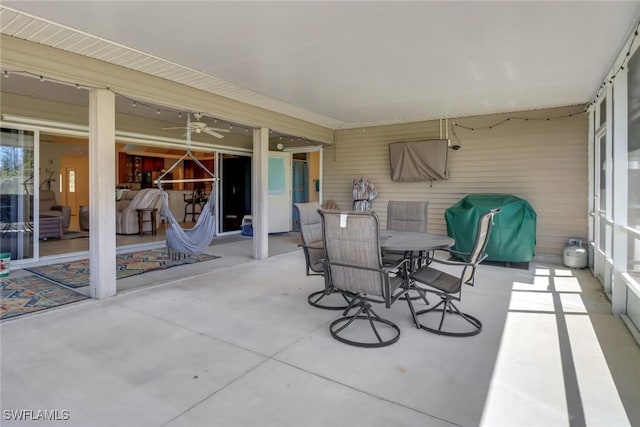 view of patio with outdoor dining area and a grill