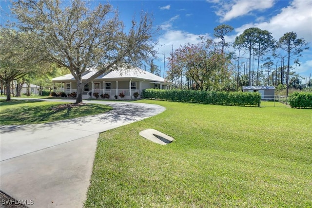 view of yard featuring covered porch and driveway