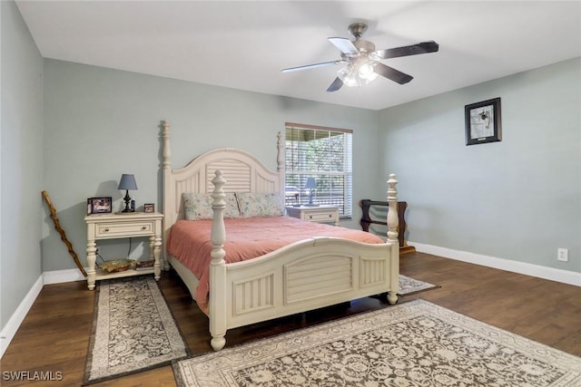 bedroom with ceiling fan, wood finished floors, and baseboards