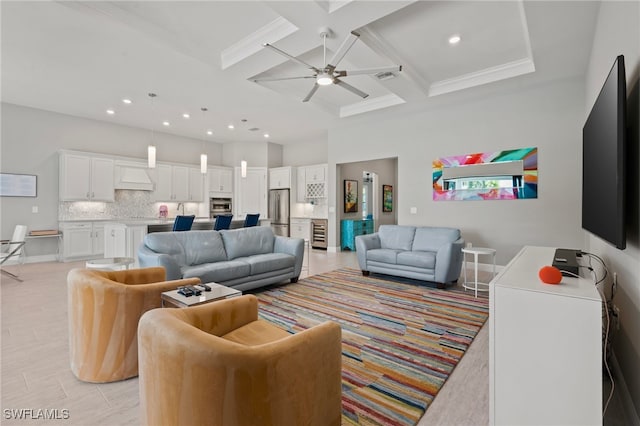 living area featuring beam ceiling, coffered ceiling, recessed lighting, a high ceiling, and ceiling fan