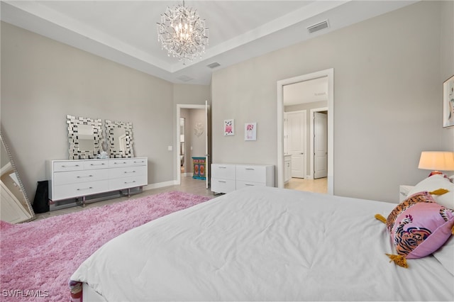 bedroom with visible vents, a raised ceiling, baseboards, and a chandelier