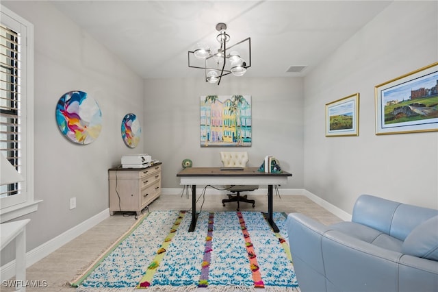 office featuring a notable chandelier, baseboards, visible vents, and light wood-type flooring