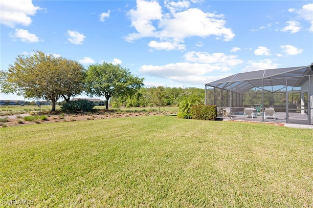 view of yard with glass enclosure