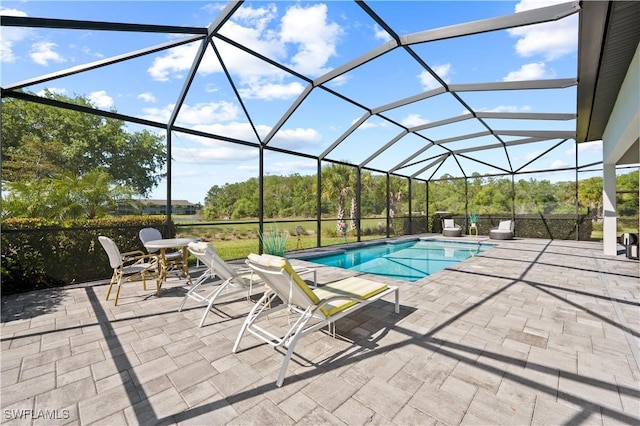 outdoor pool with a lanai and a patio