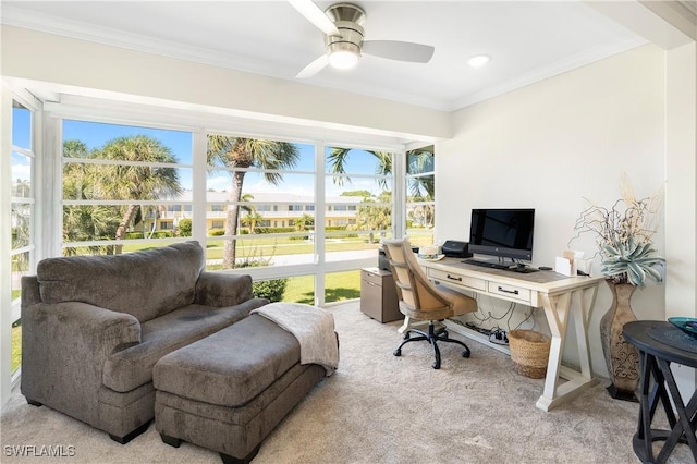 home office with light carpet, ornamental molding, and a ceiling fan