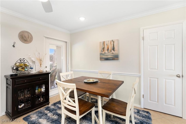 dining space with light tile patterned floors and ornamental molding