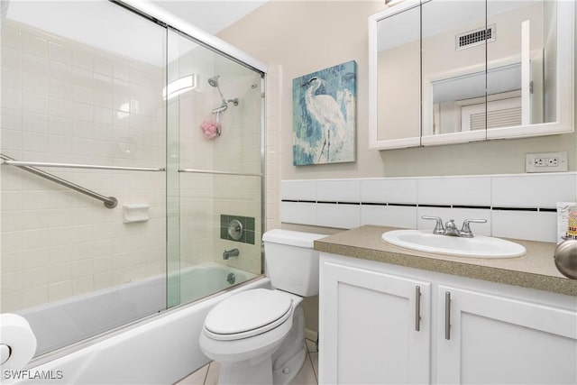 full bathroom featuring bath / shower combo with glass door, visible vents, decorative backsplash, toilet, and vanity