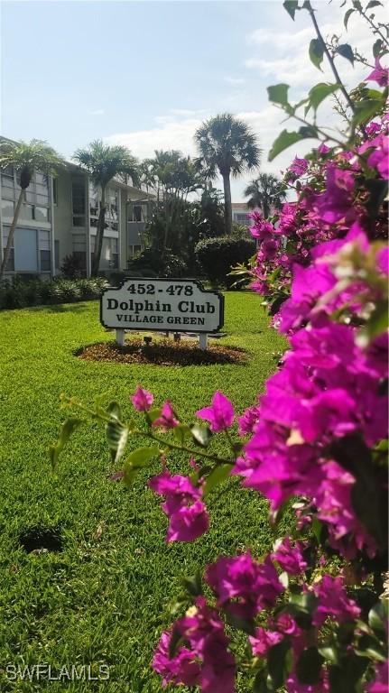 community sign featuring a lawn