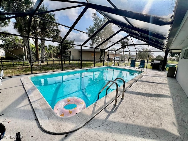 outdoor pool featuring a lanai and a patio