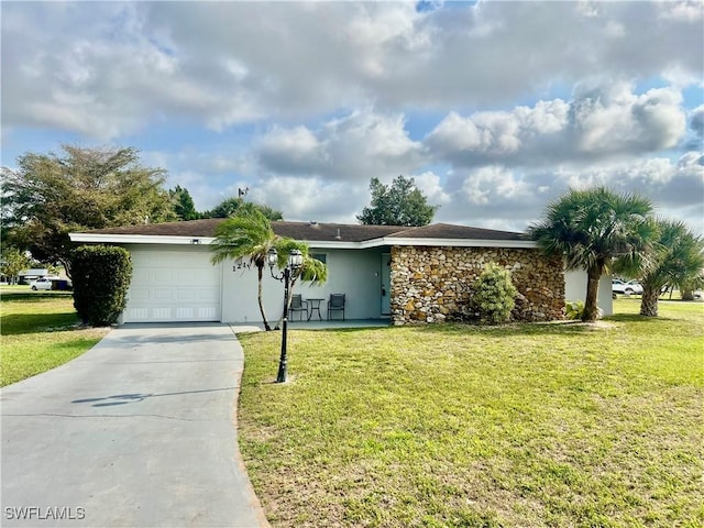 single story home with an attached garage, stone siding, a front lawn, and concrete driveway