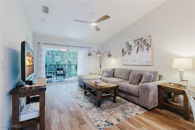 living room featuring visible vents, a ceiling fan, wood finished floors, and vaulted ceiling