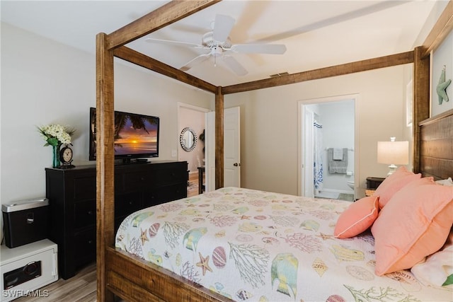 bedroom with beam ceiling, a ceiling fan, wood finished floors, ensuite bath, and visible vents