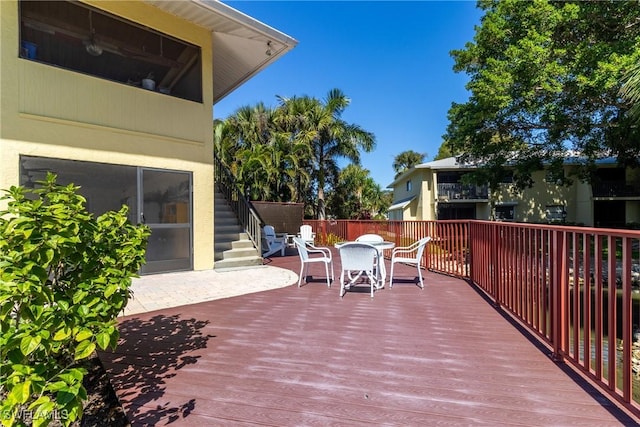 wooden terrace featuring outdoor dining area