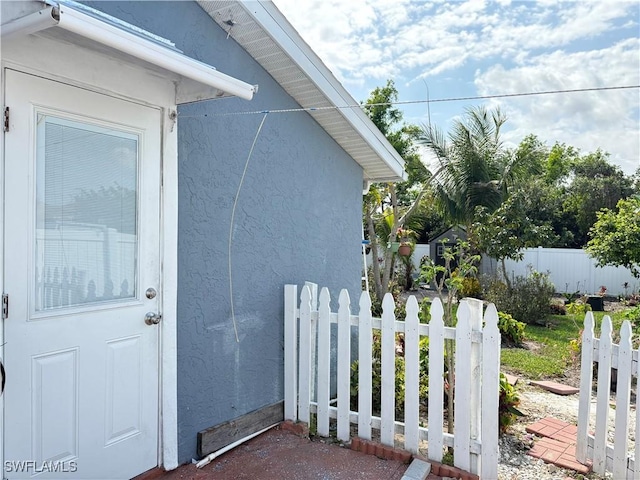 exterior space with fence and stucco siding