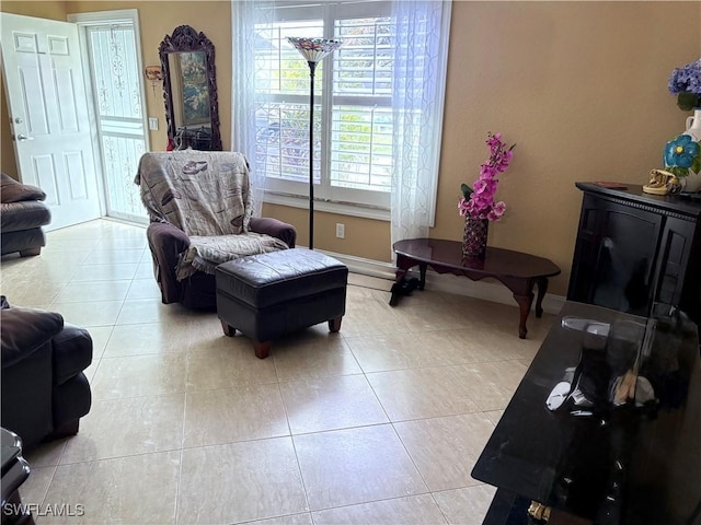 tiled living area featuring baseboards