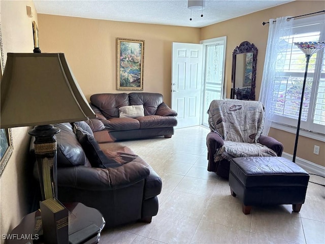 living area featuring light tile patterned floors and a textured ceiling