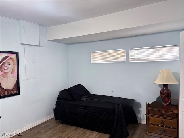 bedroom featuring baseboards and wood finished floors