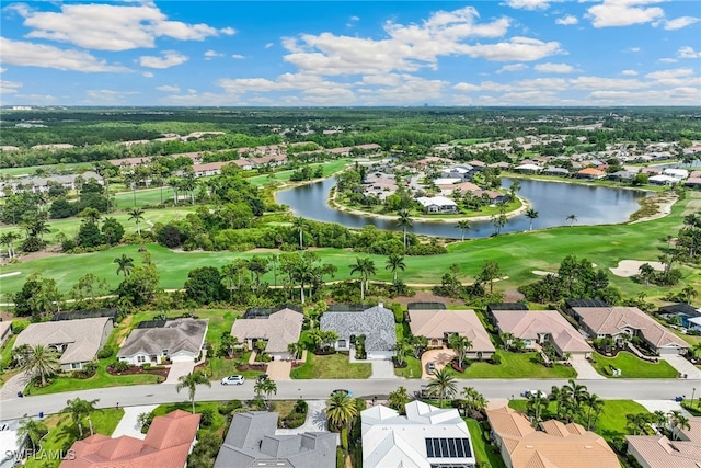 aerial perspective of suburban area featuring a golf course and a large body of water