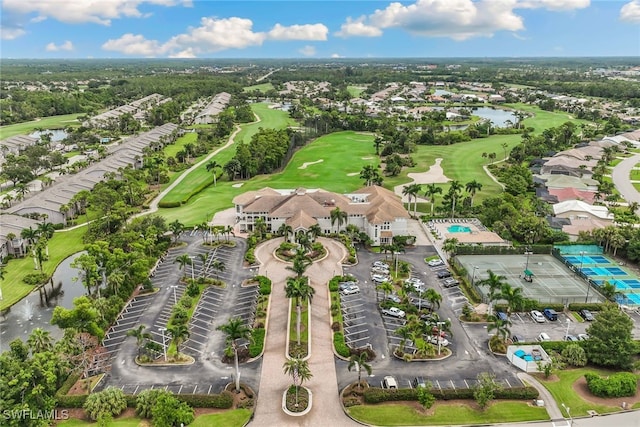 aerial perspective of suburban area featuring a large body of water and a golf club