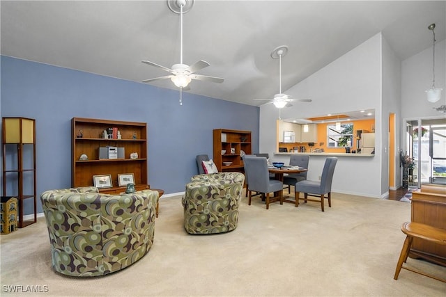 sitting room featuring baseboards, carpet floors, high vaulted ceiling, and a ceiling fan