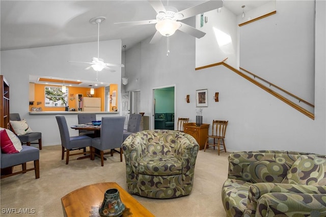 living area featuring a ceiling fan, carpet, and high vaulted ceiling