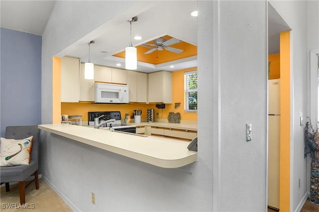 kitchen with pendant lighting, recessed lighting, a peninsula, white appliances, and a raised ceiling