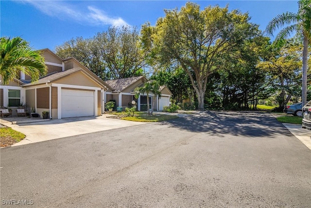 view of front of home with concrete driveway and an attached garage