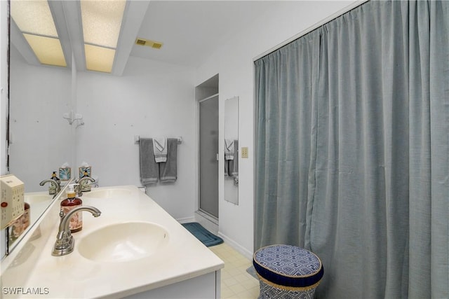 full bath featuring a sink, visible vents, a stall shower, and double vanity