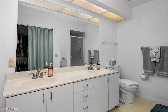 bathroom with a sink, toilet, double vanity, and a shower stall