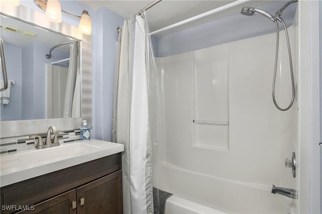 full bathroom featuring decorative backsplash, vanity, visible vents, and shower / bath combo