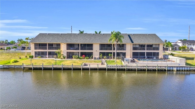 rear view of property with a water view and a residential view