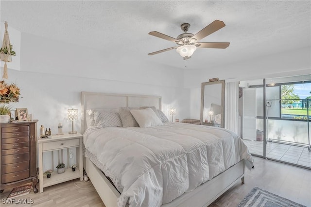 bedroom featuring a textured ceiling, access to outside, light wood finished floors, and a ceiling fan