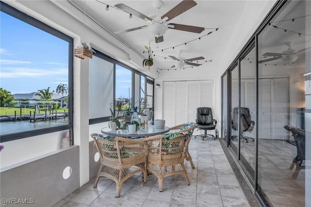 sunroom featuring a ceiling fan