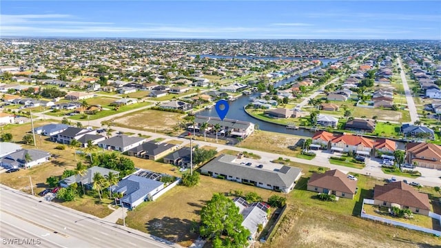 birds eye view of property with a water view and a residential view