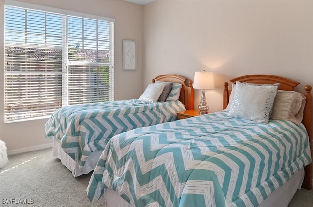 bedroom with carpet flooring and baseboards