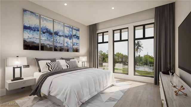 bedroom with light wood finished floors and recessed lighting